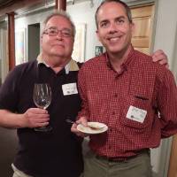 two men pose for photo